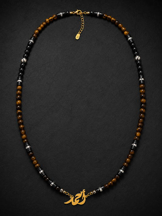 Necklace with beads and gold charm on a dark background