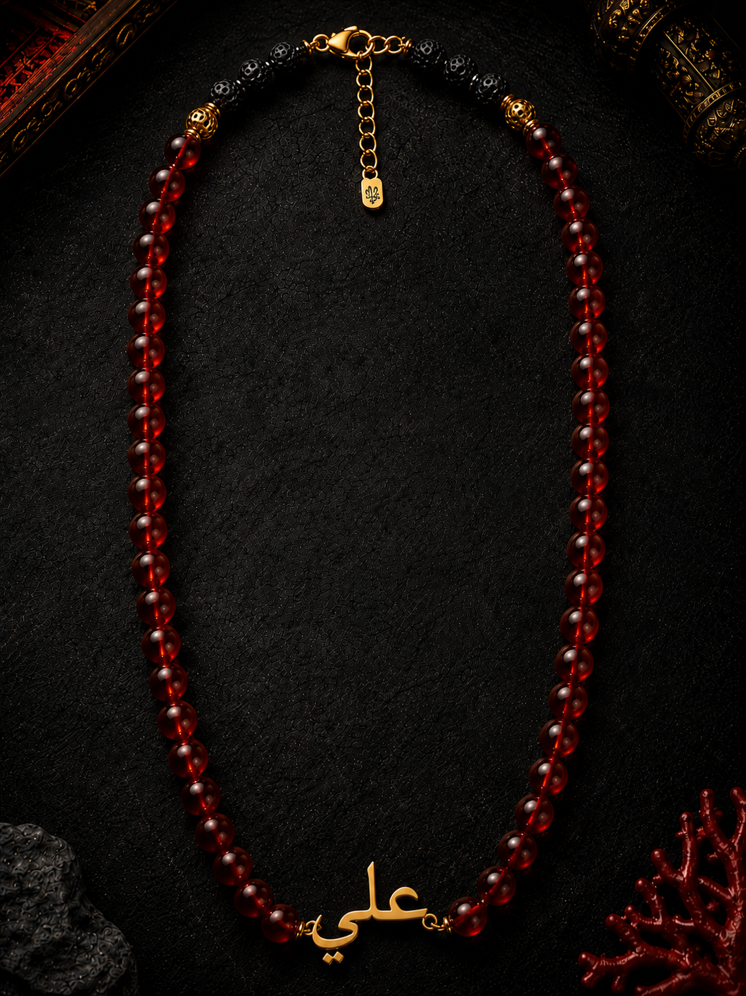 Necklace with red beads and gold accents on a dark background