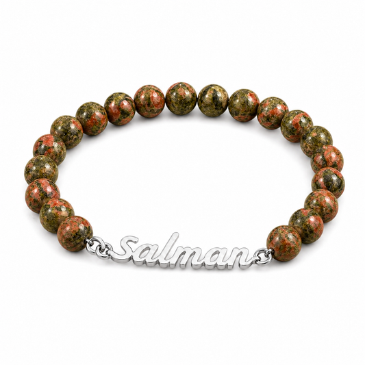 Beaded bracelet with red and green stones on a white background, branded 'Salman'.