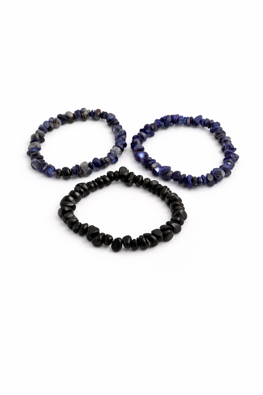Three beaded bracelets in black and blue on a white background