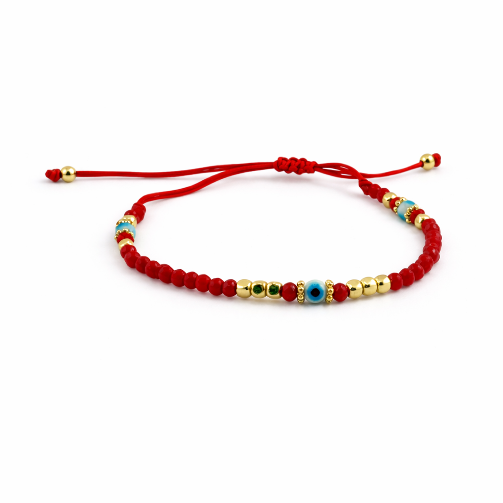 Red beaded bracelet with gold and blue beads on a white background