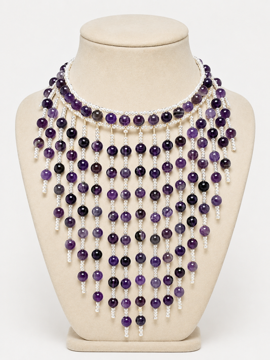 Necklace with purple and white beads on a mannequin bust against a white background