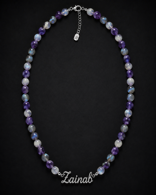 Necklace with multicolored beads and 'Lainab' clasp on a black background