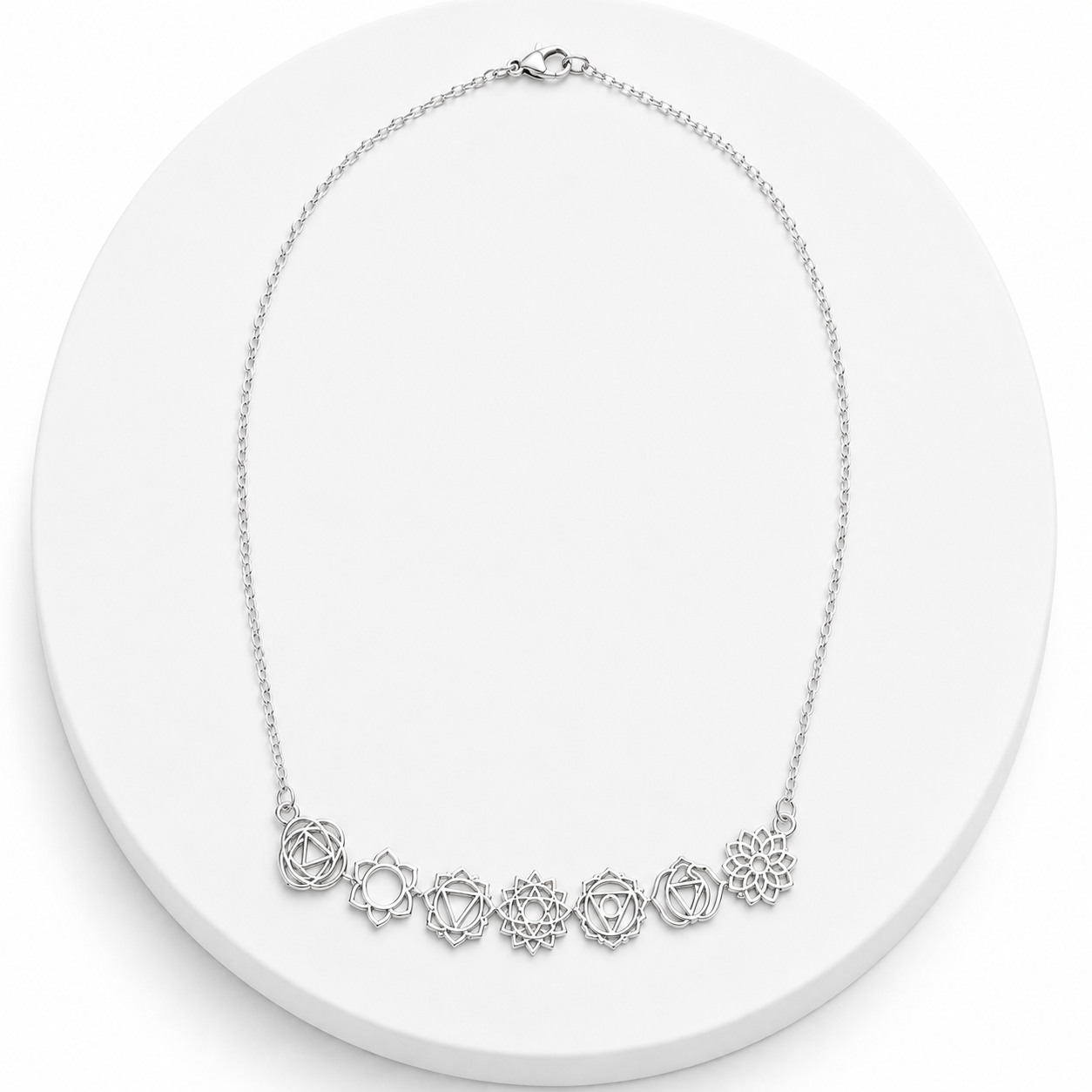 Silver necklace with floral designs on a white background