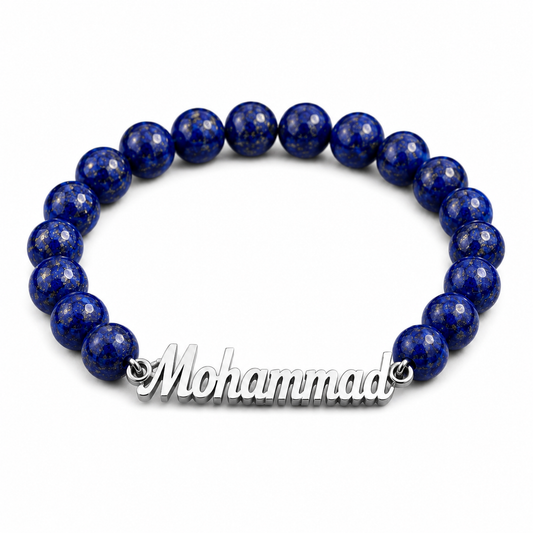 Blue beaded bracelet with a silver nameplate on a white background