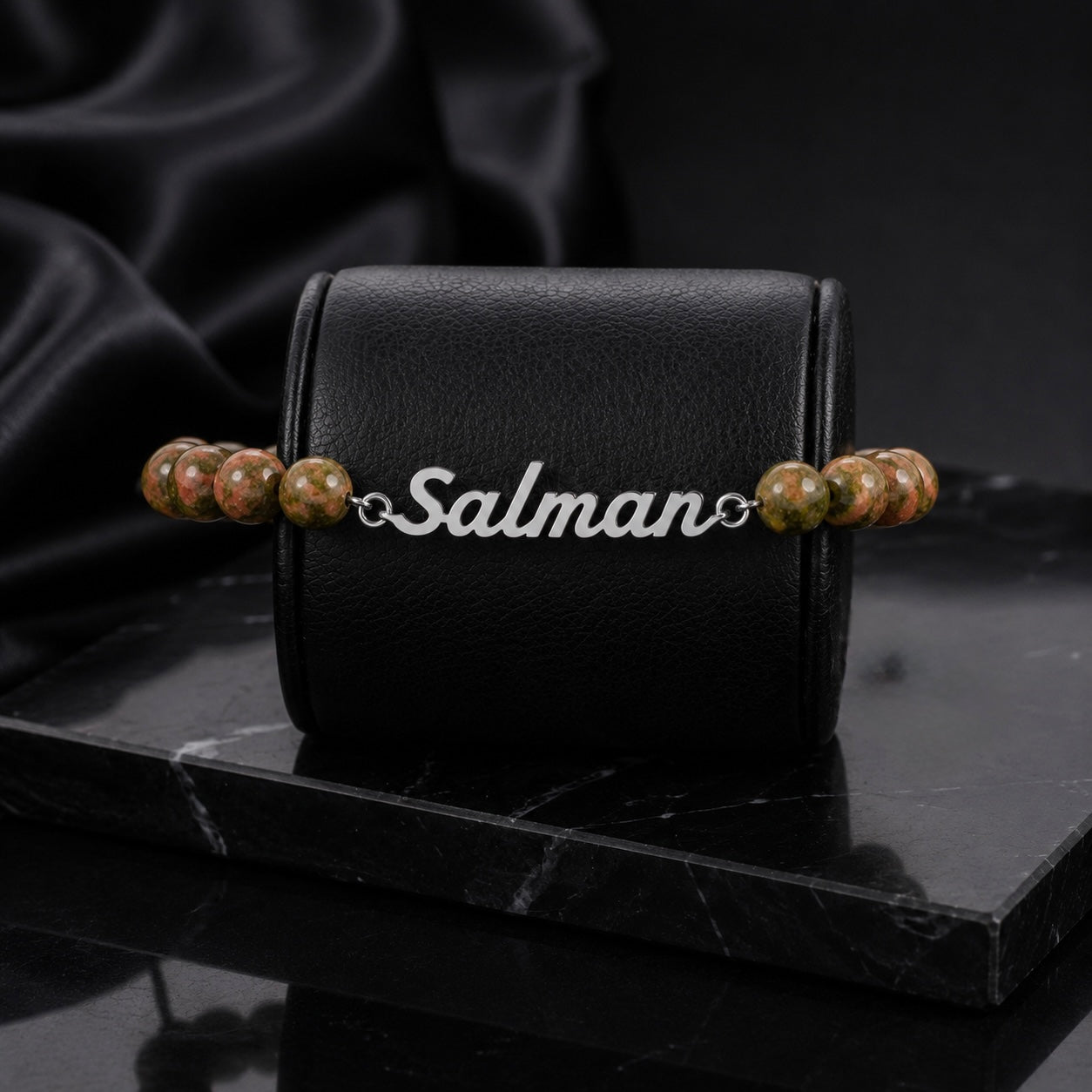 Bracelet with 'Salman' engraving on a black marble surface