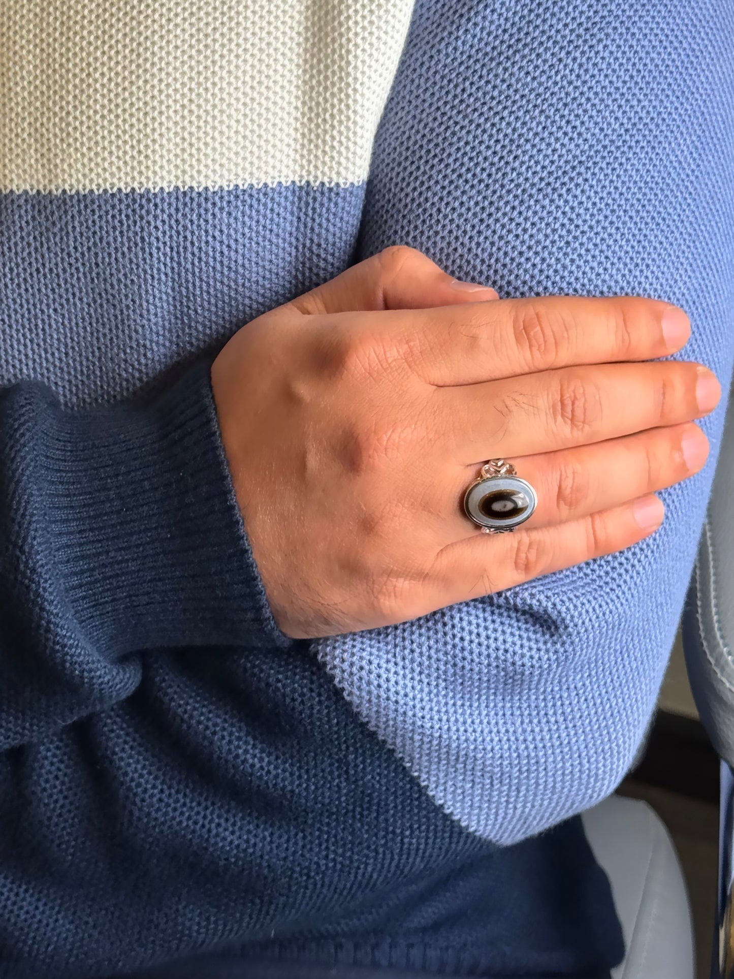 Close up of Black Agate gemstone ring on a man’s hand