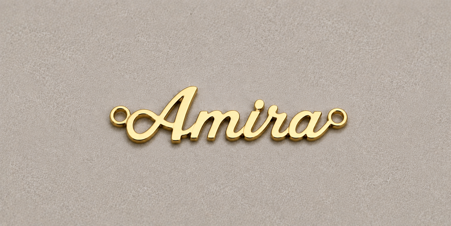 Gold nameplate with 'Amira' on a beige background