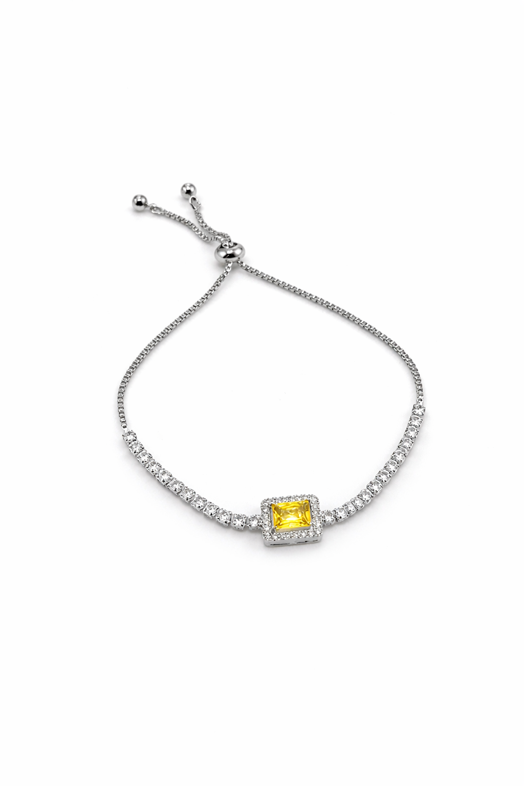 Silver bracelet with a yellow gemstone on a white background