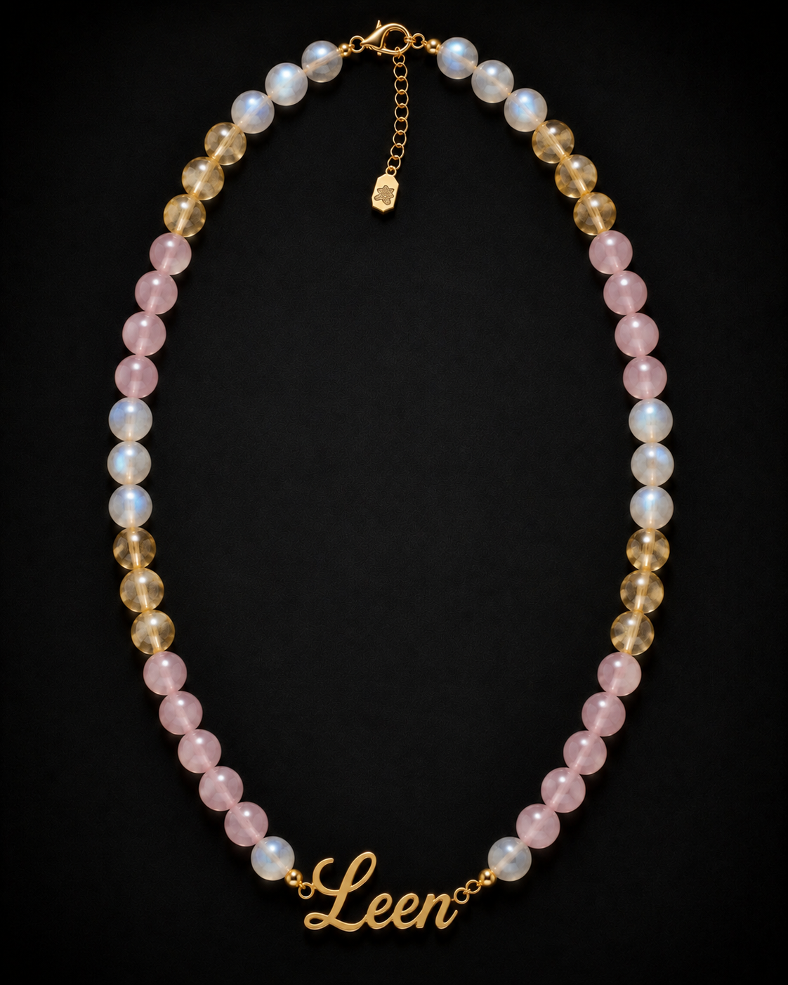 Necklace with multicolored beads and a gold chain on a black background