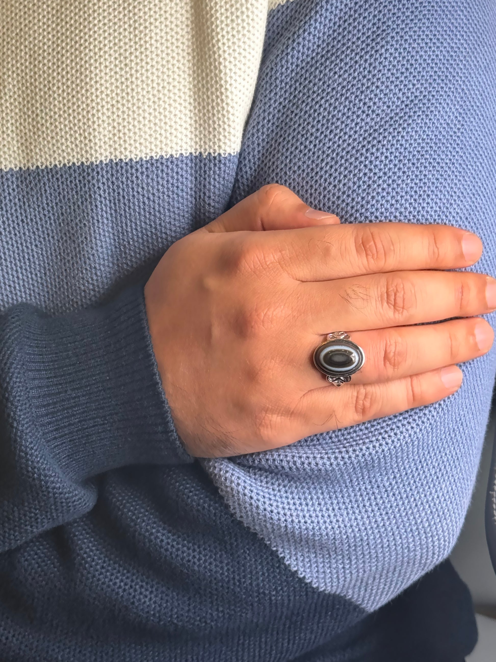Close up of Black Onyx gemstone ring on a man’s hand