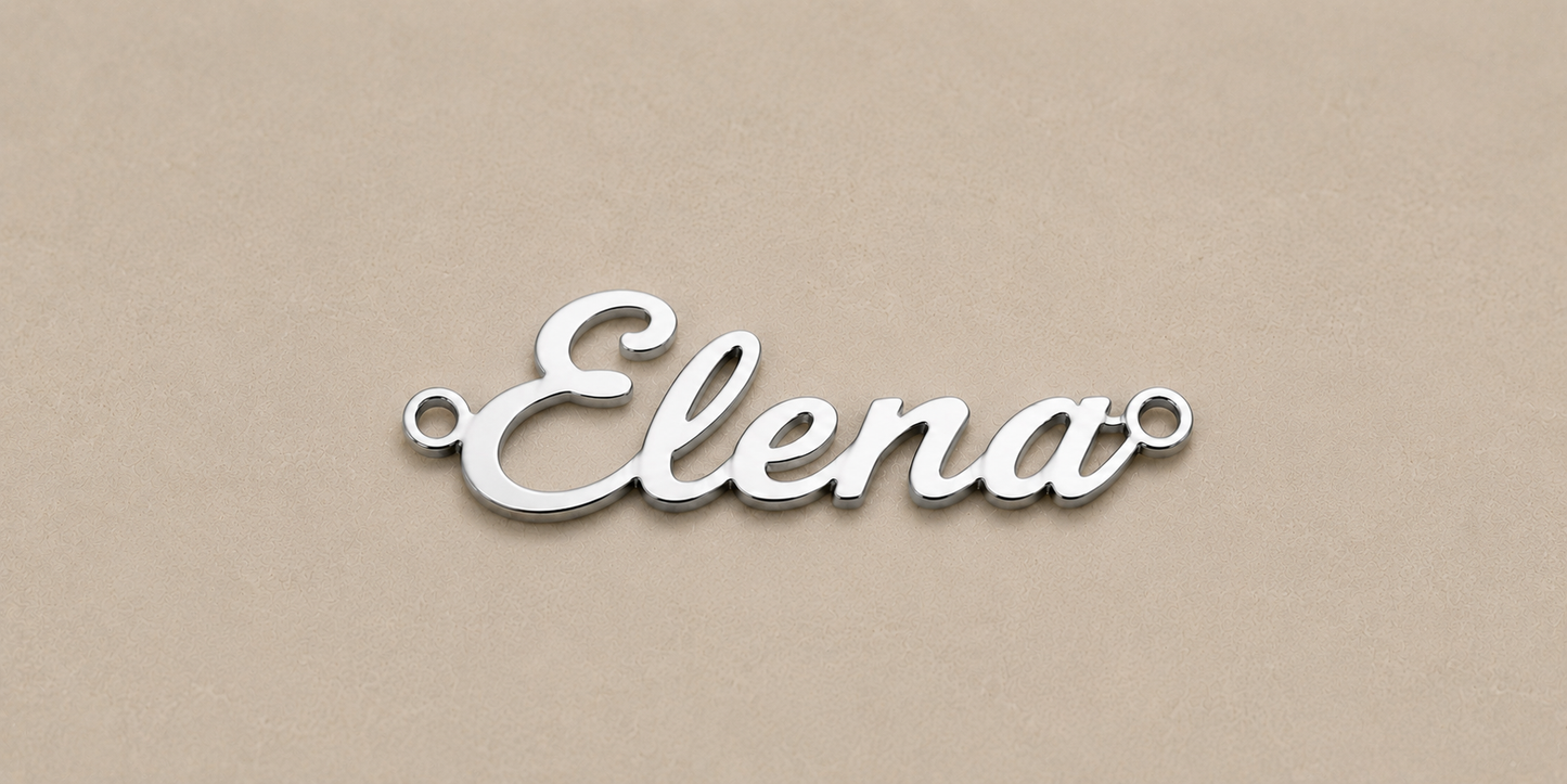 Silver nameplate with 'Elena' on a beige background