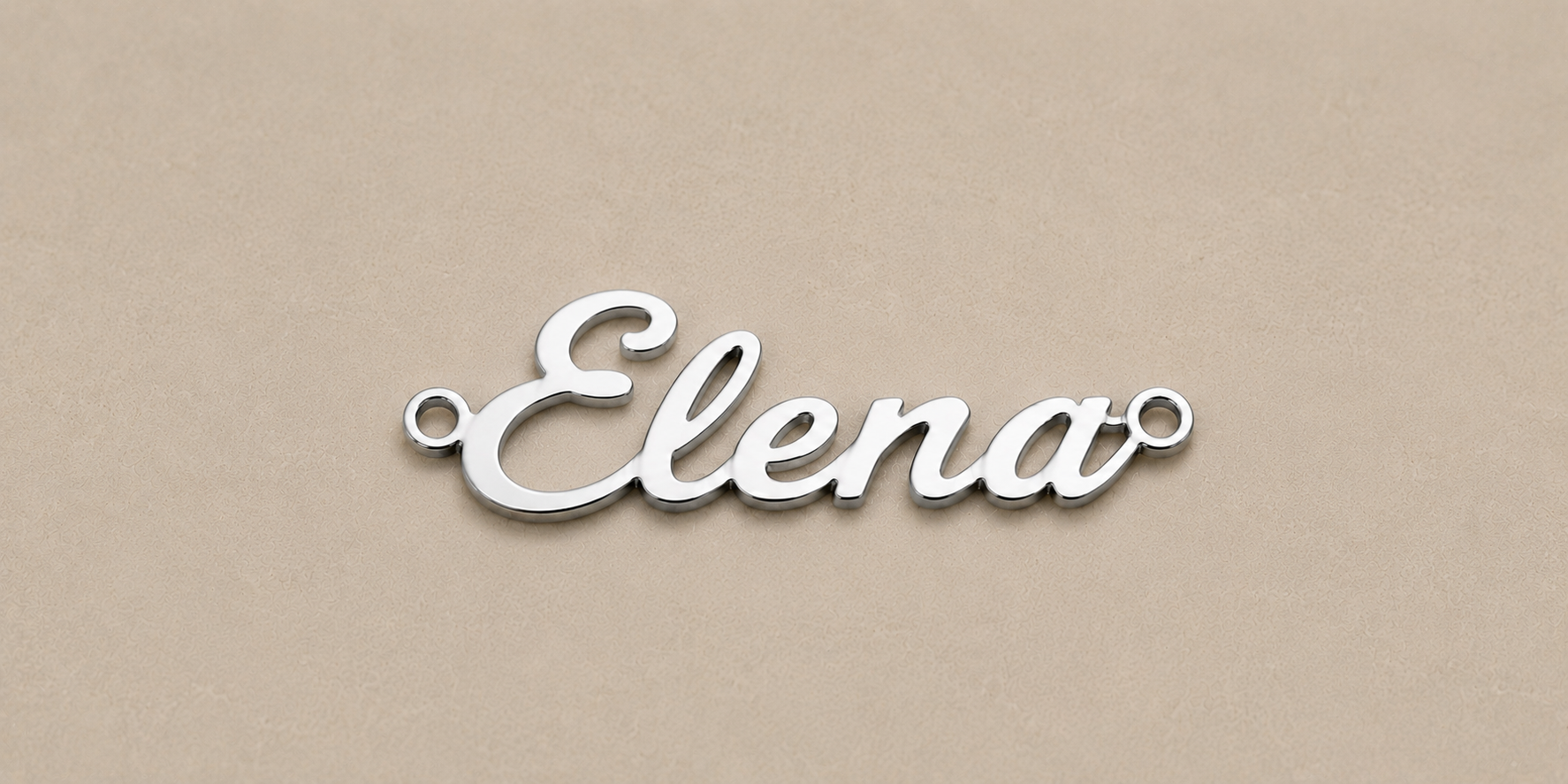 Silver nameplate with 'Elena' on a beige background