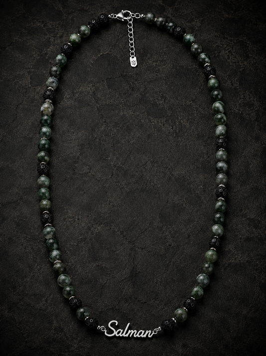 Necklace with black and green beads on a dark background