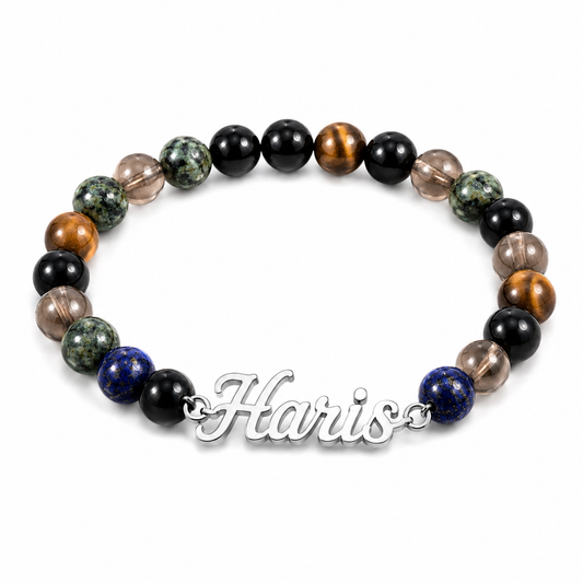 Multicolored beaded bracelet with a silver nameplate on a white background