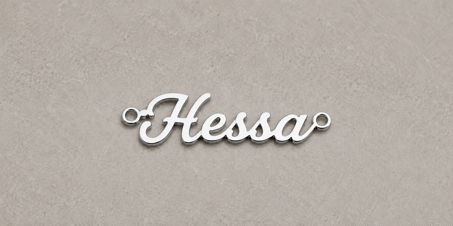 Silver nameplate with 'Hessa' on a beige background