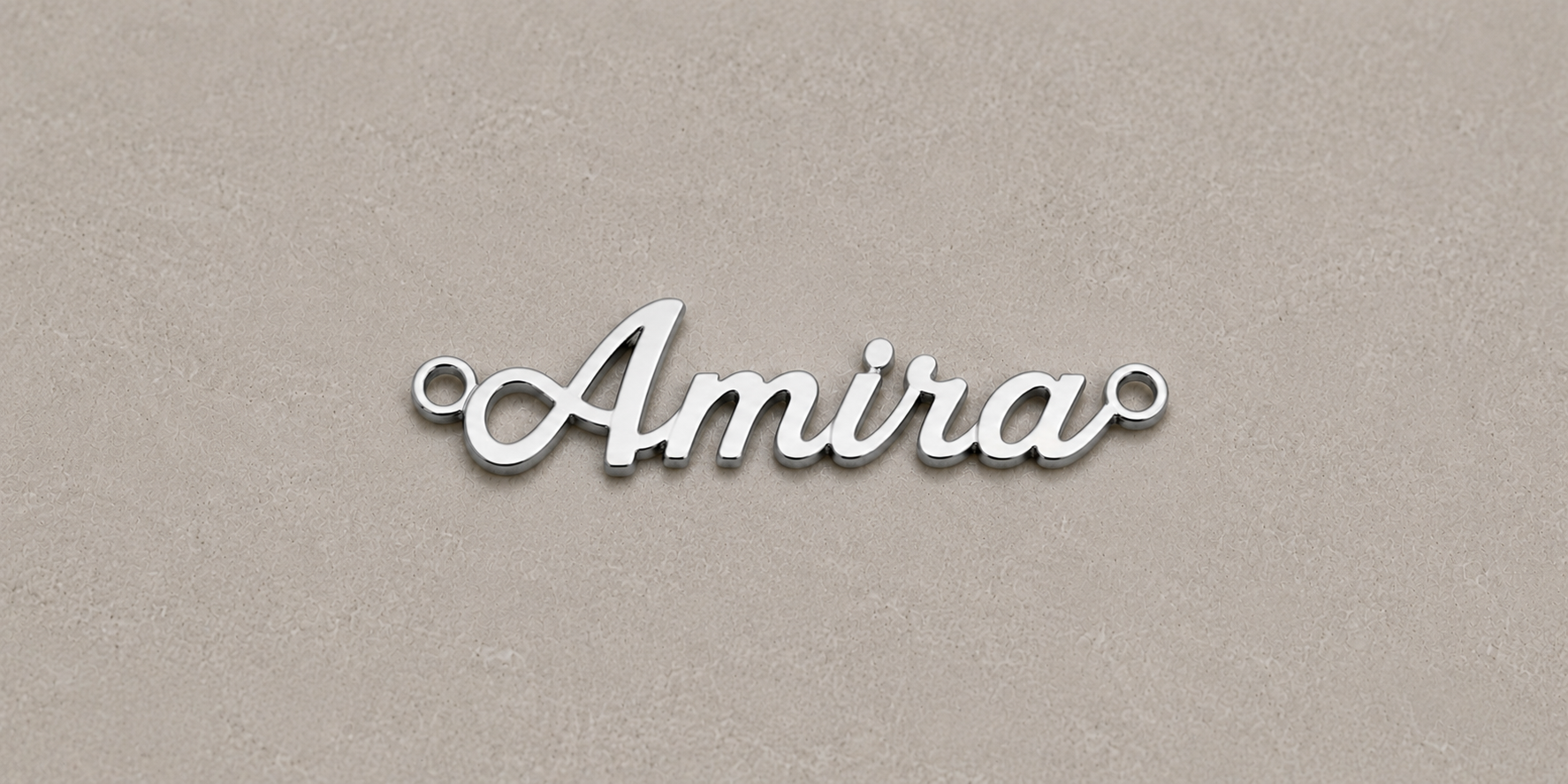 Silver 'Amira' nameplate on a beige background