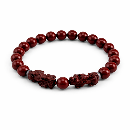 Red beaded bracelet with decorative elements on a white background