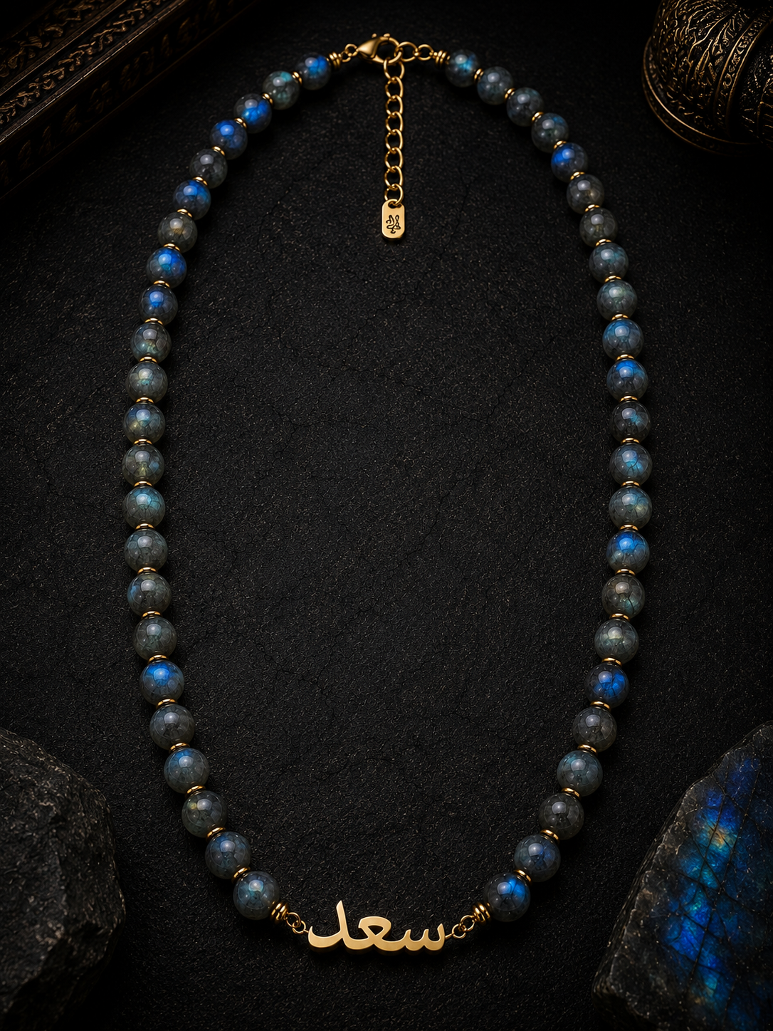 Necklace with blue beads and gold accents on a dark background