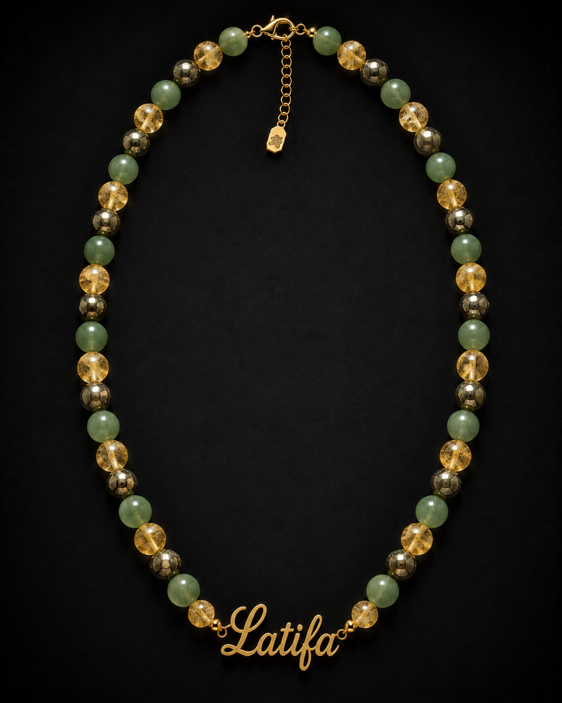 Necklace with multicolored beads and a gold chain on a black background