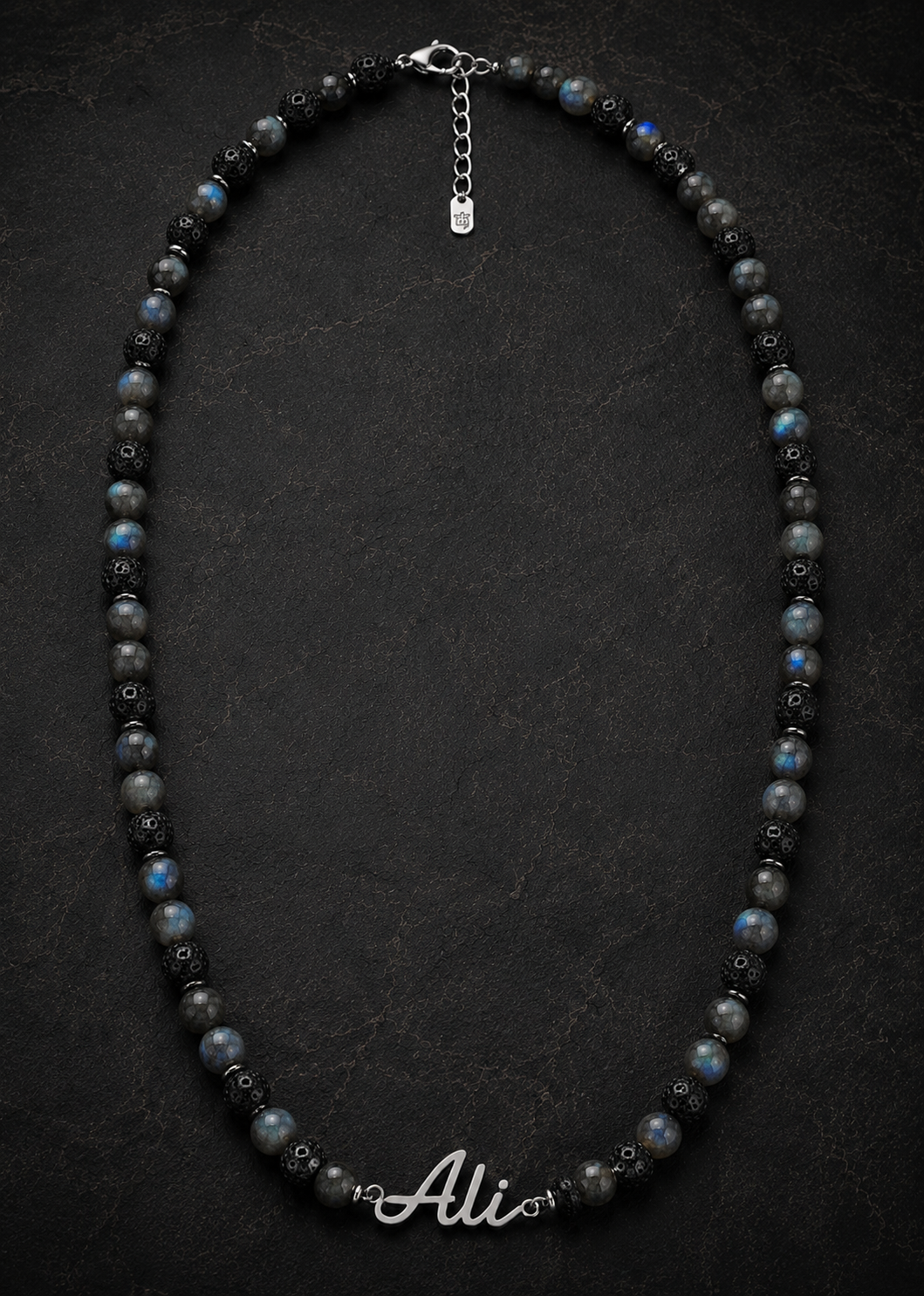 Necklace with black and gray beads on a dark background