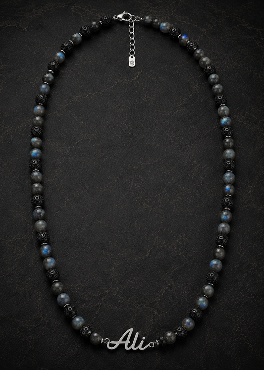 Necklace with black and gray beads on a dark background