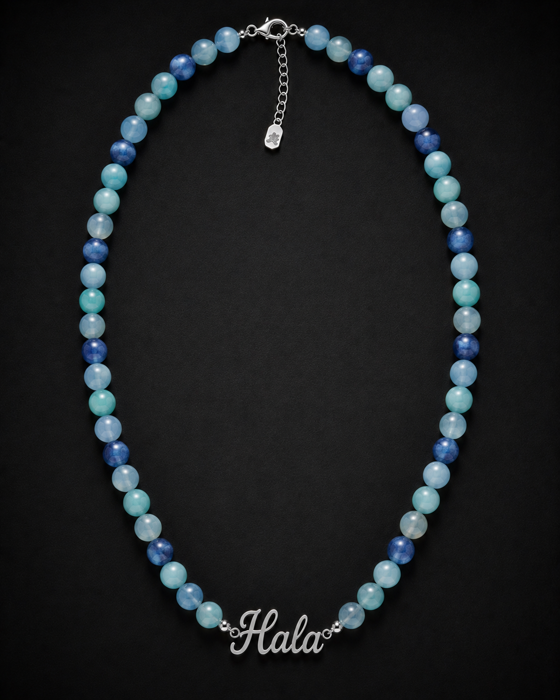 Necklace with blue and green beads on a black background