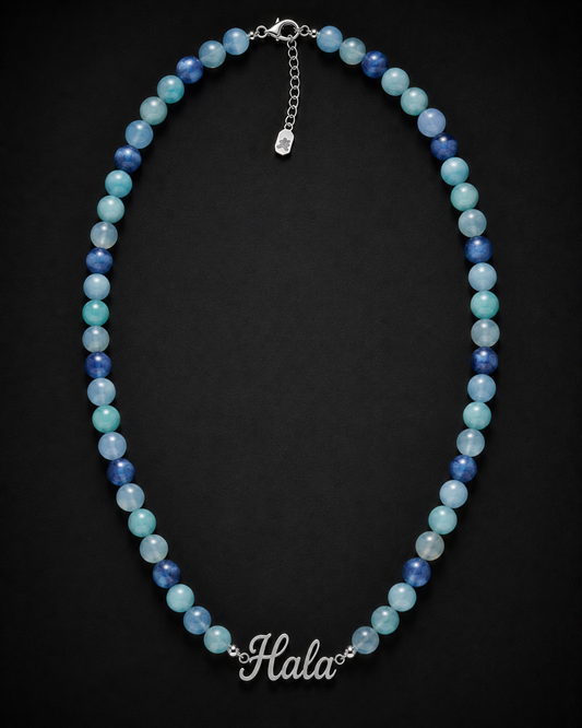 Necklace with blue and green beads on a black background