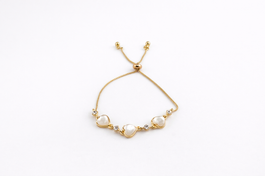 Gold bracelet with pearls on a white background