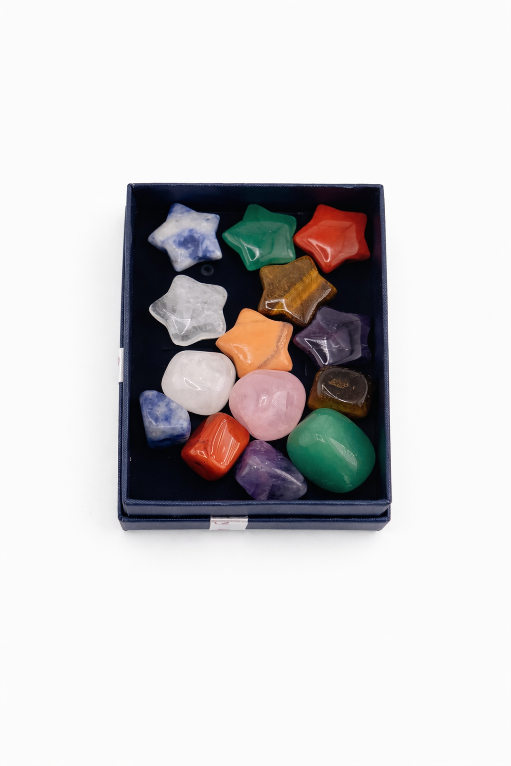 Box of colorful star-shaped stones on a white background