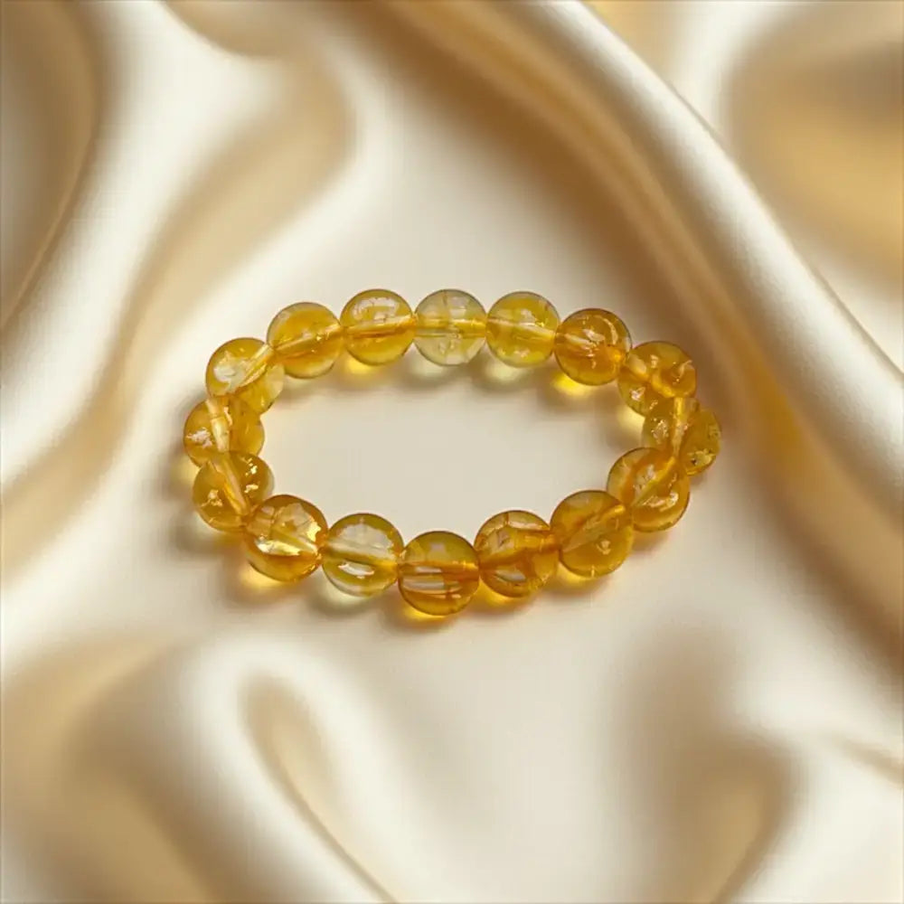 Yellow beaded bracelet on a satin surface