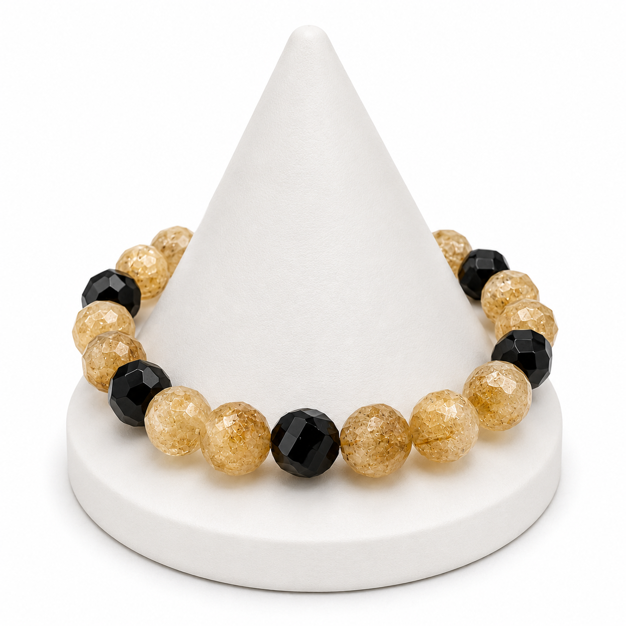 Bracelet with gold and black beads on a white cone-shaped stand
