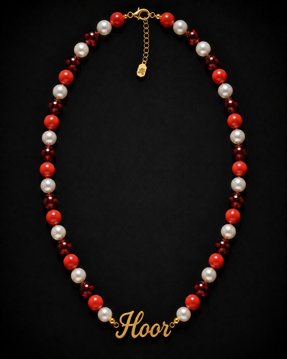 Necklace with red, white, and burgundy beads and gold 'Floor' charm on a black background