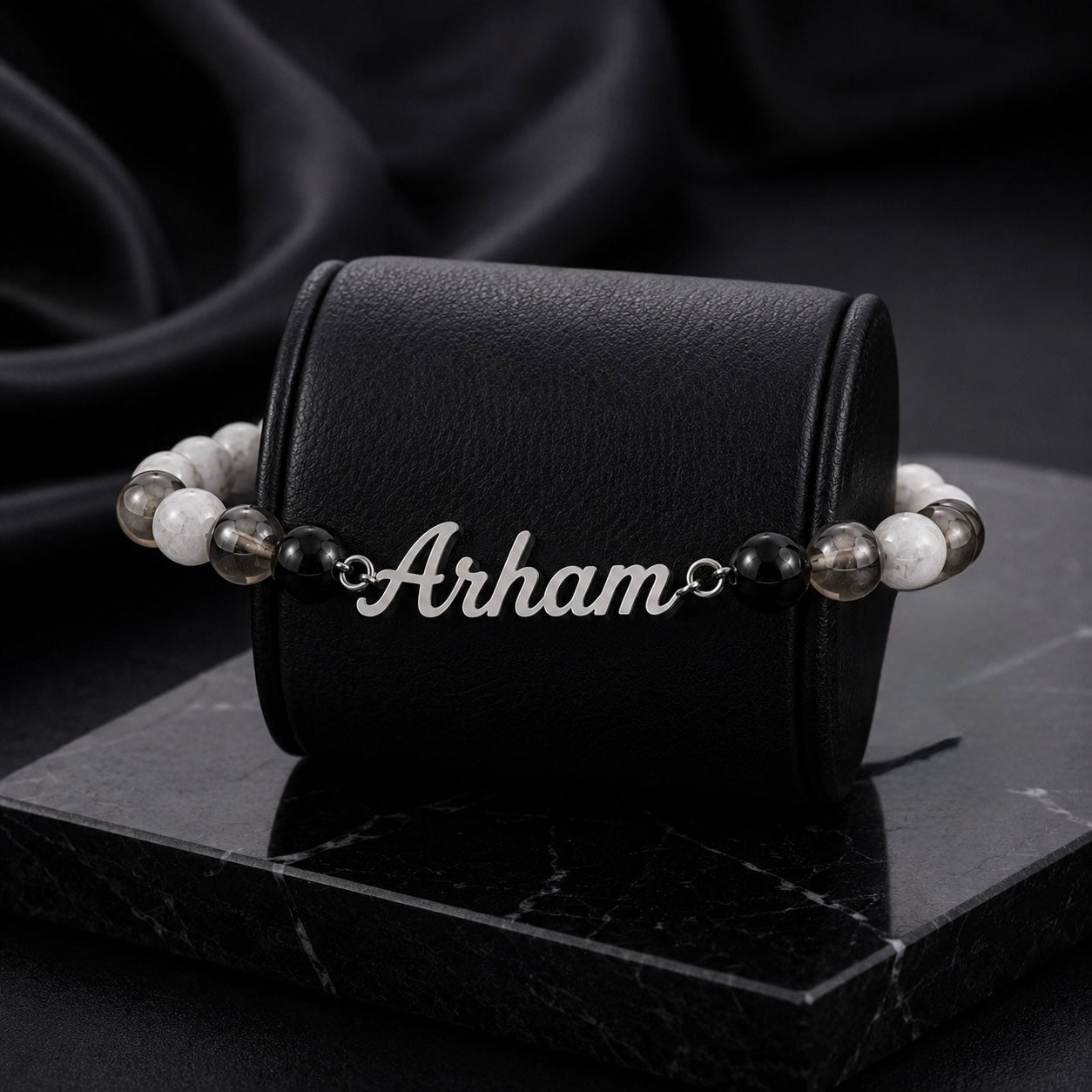 Bracelet with 'Arham' engraving on a black leather case