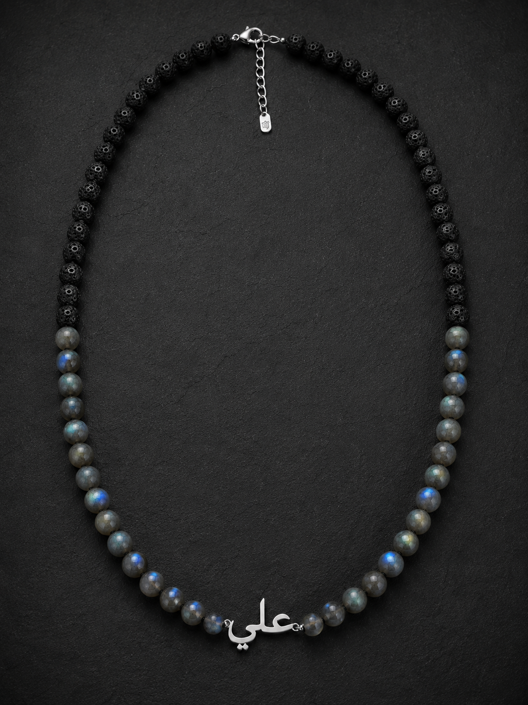 Necklace with black and gray beads on a dark background