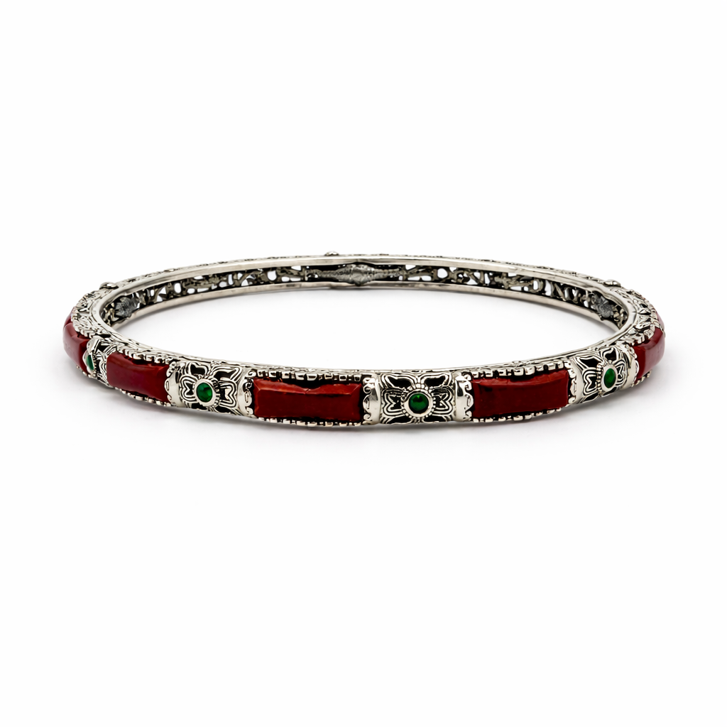 Silver bracelet with red and green accents on a white background
