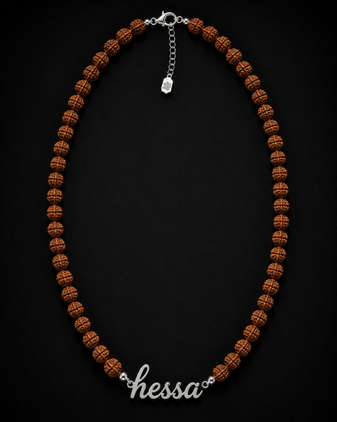 Brown beaded necklace with a silver chain on a black background