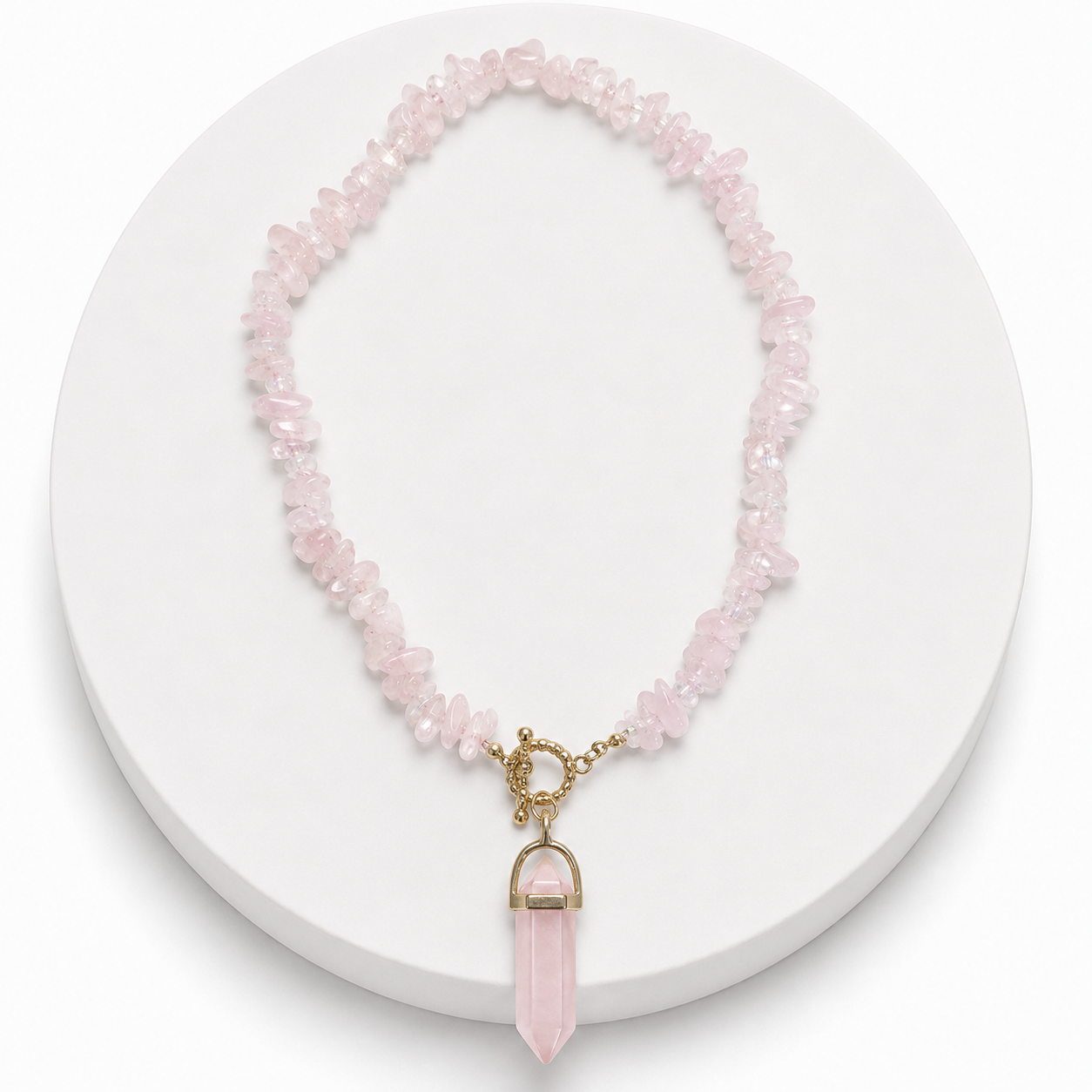Necklace with pink beads and a gold pendant on a white background