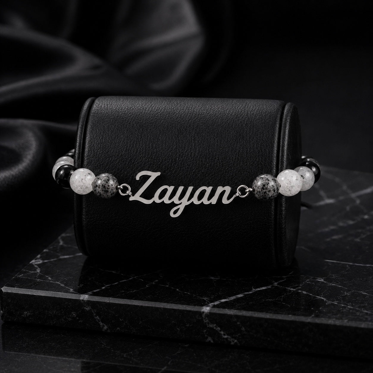Bracelet with 'Zayan' engraving on a black leather case