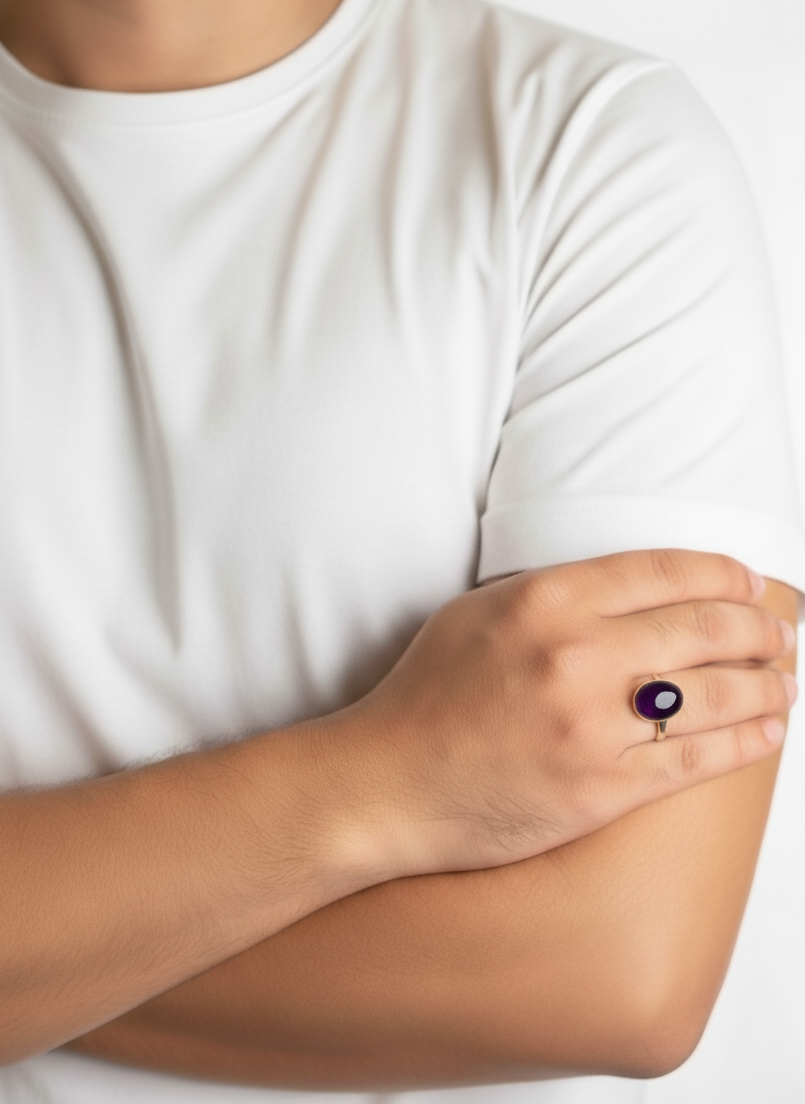 Person wearing a white t-shirt with a visible ring on an arm.