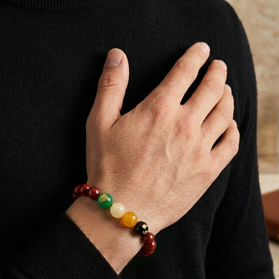 Hand wearing a colorful beaded bracelet with a blurred background