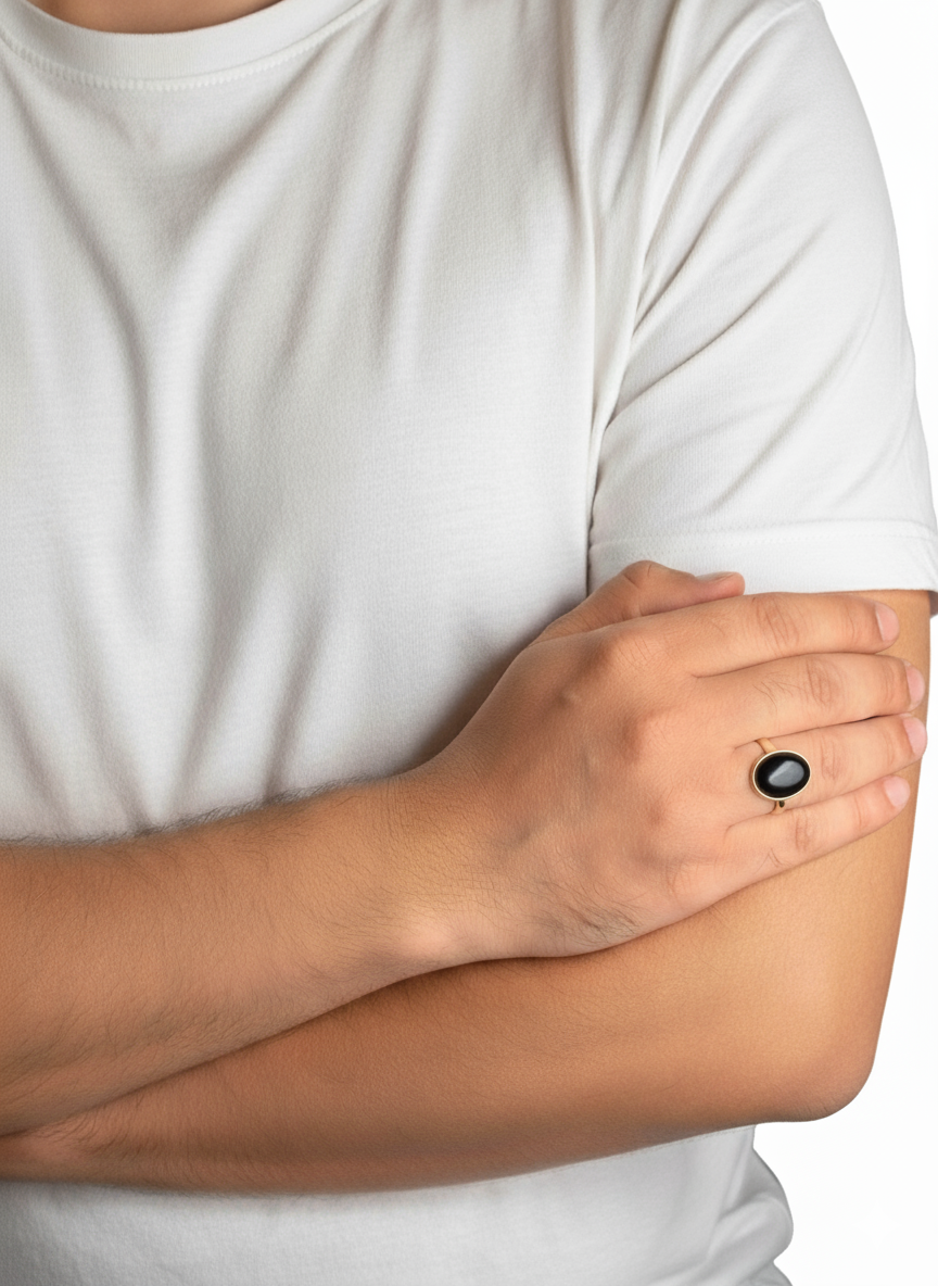 Close-up of hands with a black ring on a neutral background