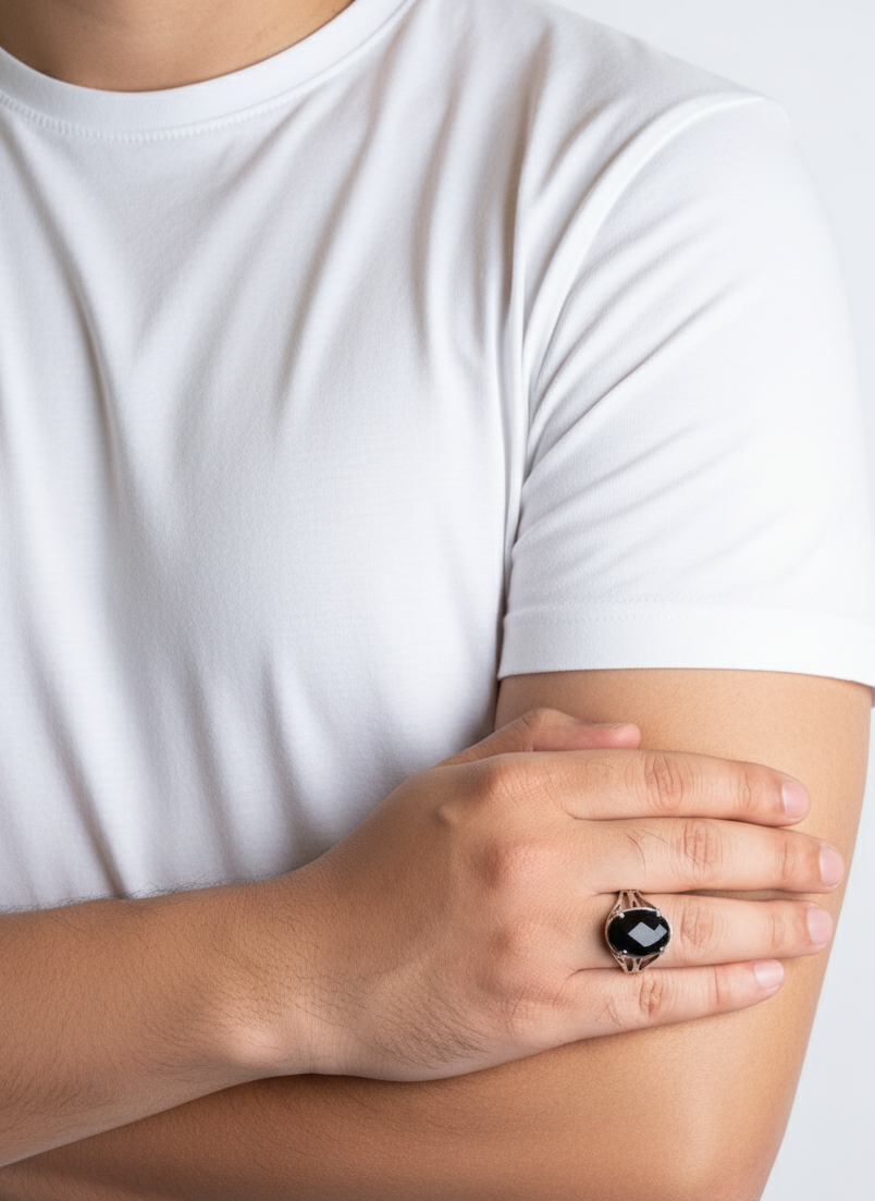 Person wearing a black ring on a white background