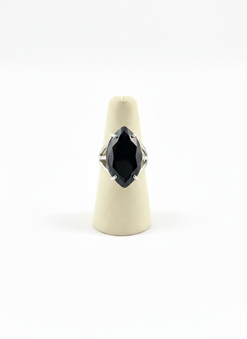 Ring with a black gemstone on a white background