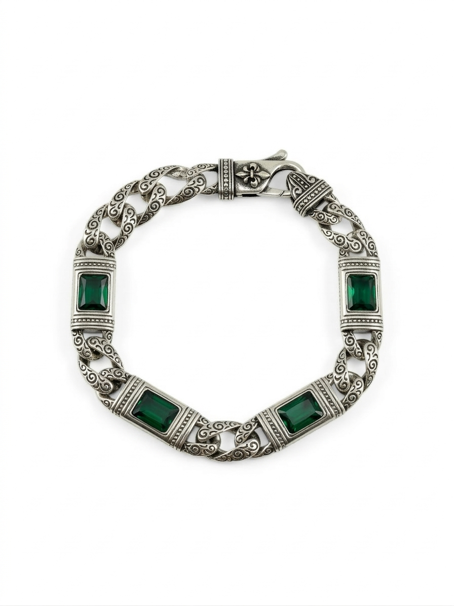 Silver bracelet with green gemstones on a white background
