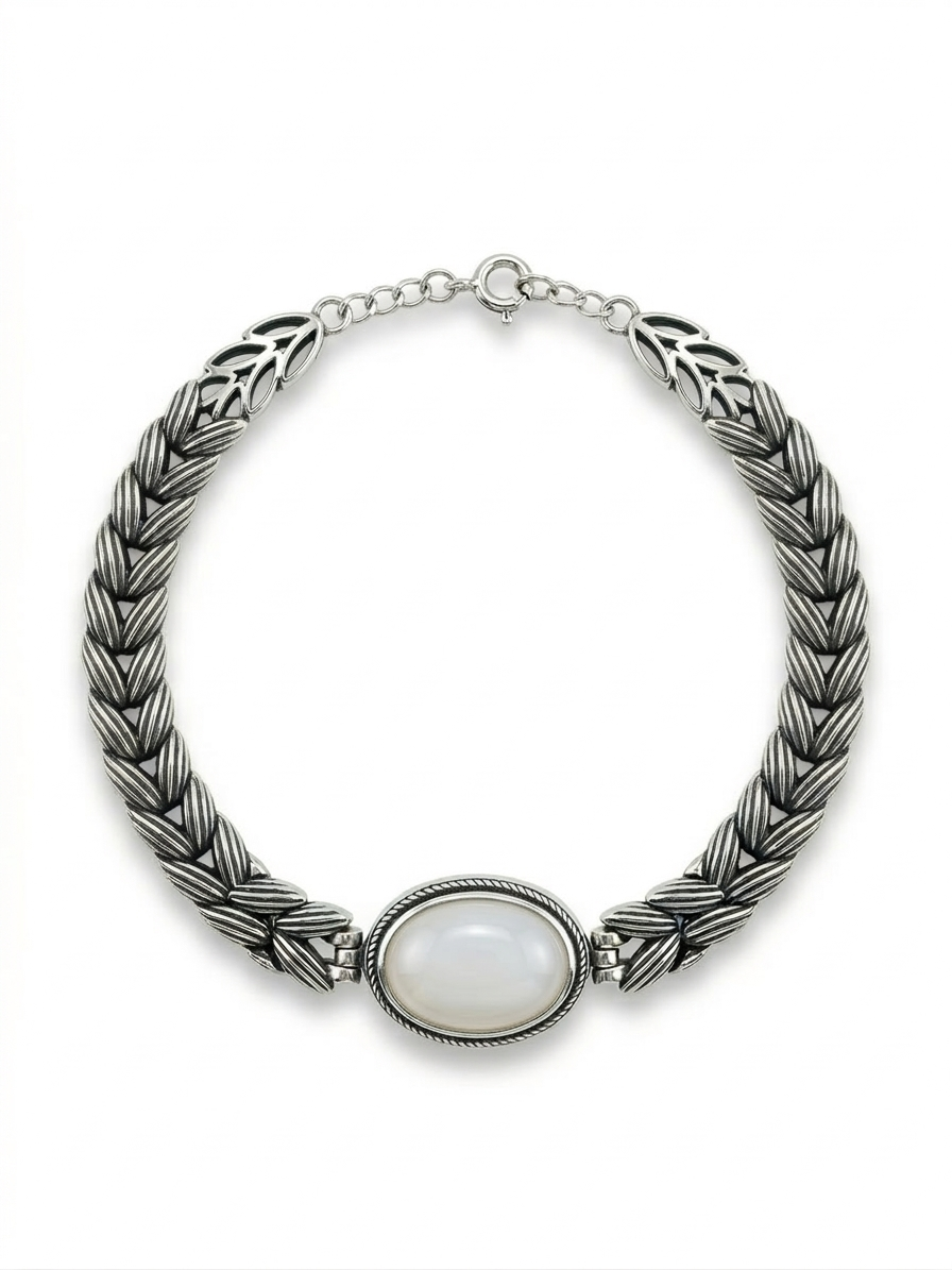 Silver braided necklace with a central stone on a white background