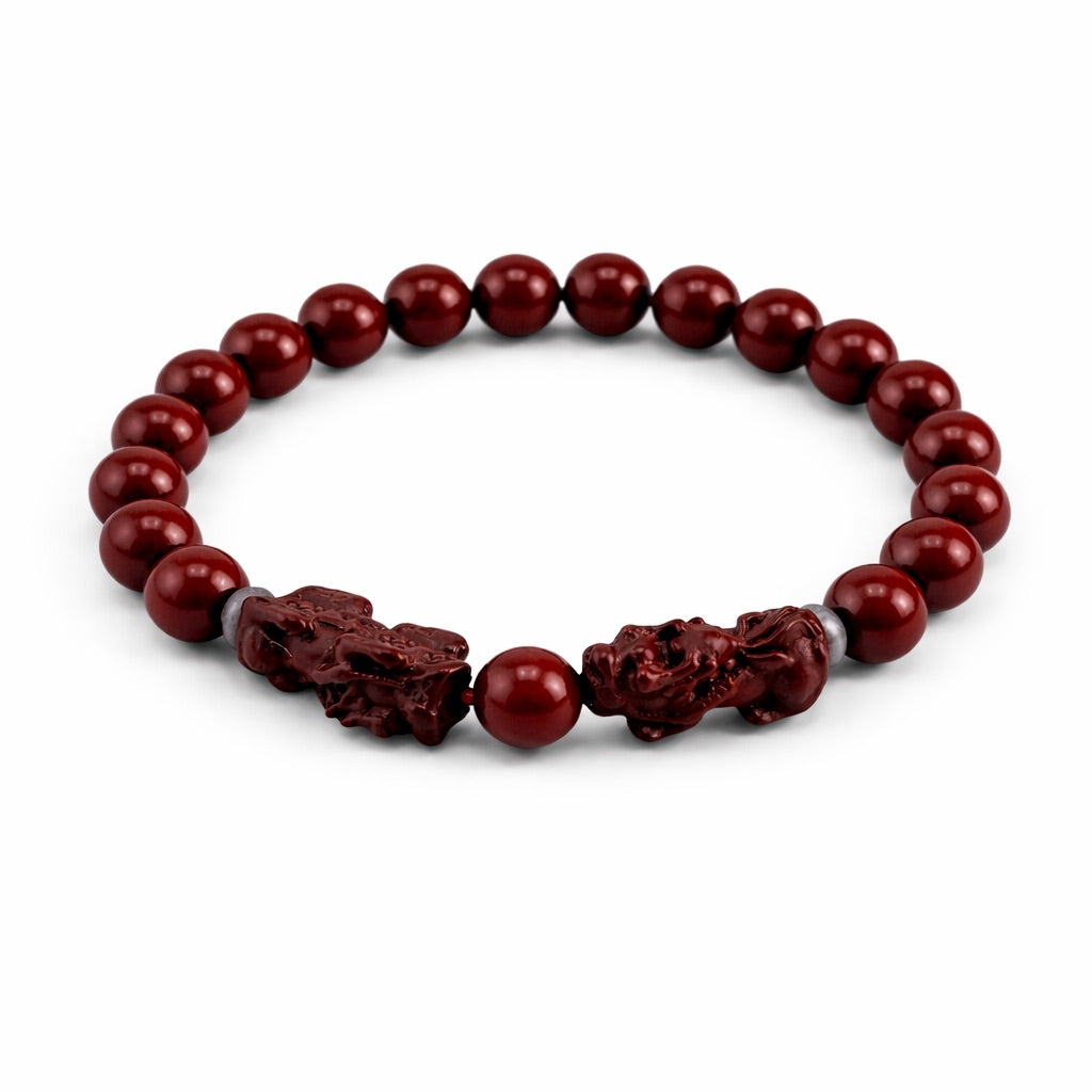 Red beaded bracelet with decorative elements on a white background