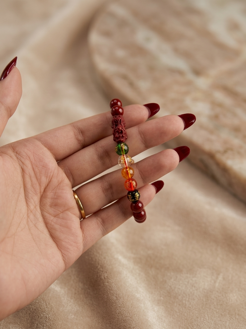 Hand holding a beaded bracelet with a neutral background