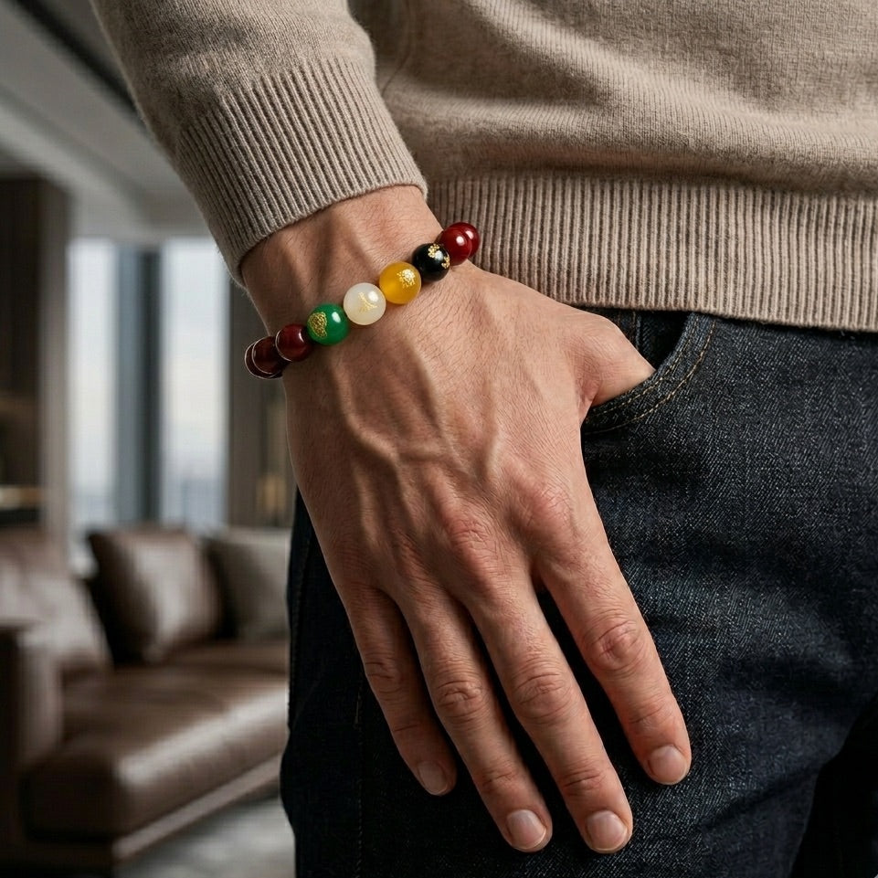Person wearing a colorful beaded bracelet in a living room setting
