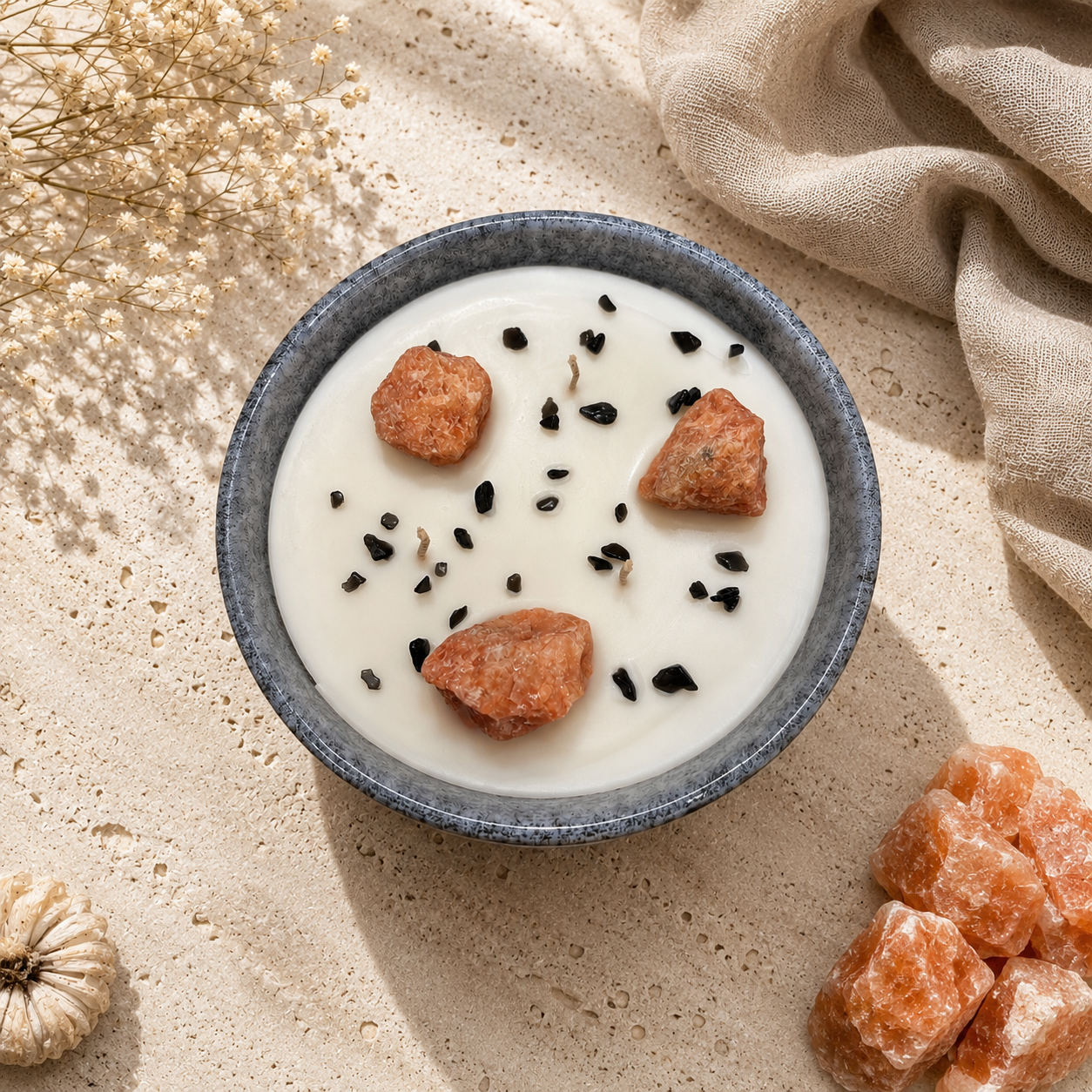 Bowl of yogurt with granola and berries on a textured surface